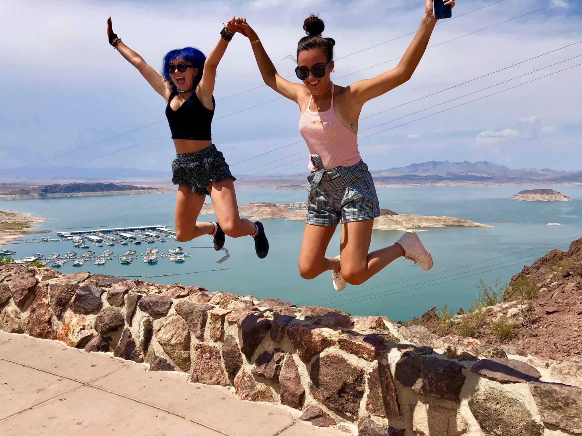 a group of people standing next to a body of water