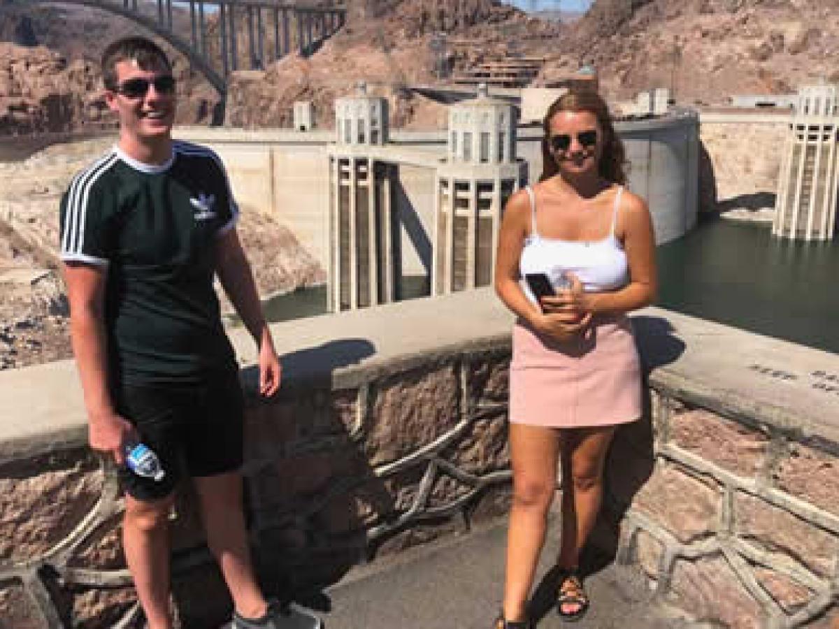 a man and a woman standing in front of a building