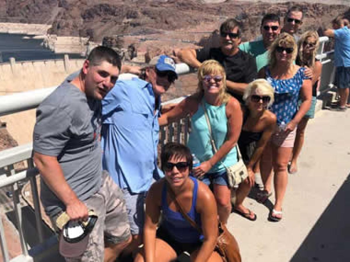 a group of people walking in the sand