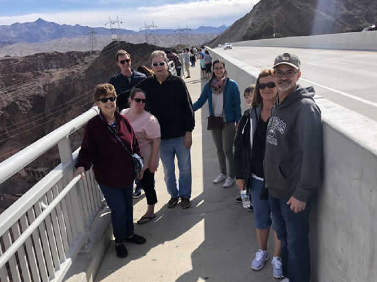 a group of people standing on the side of a mountain